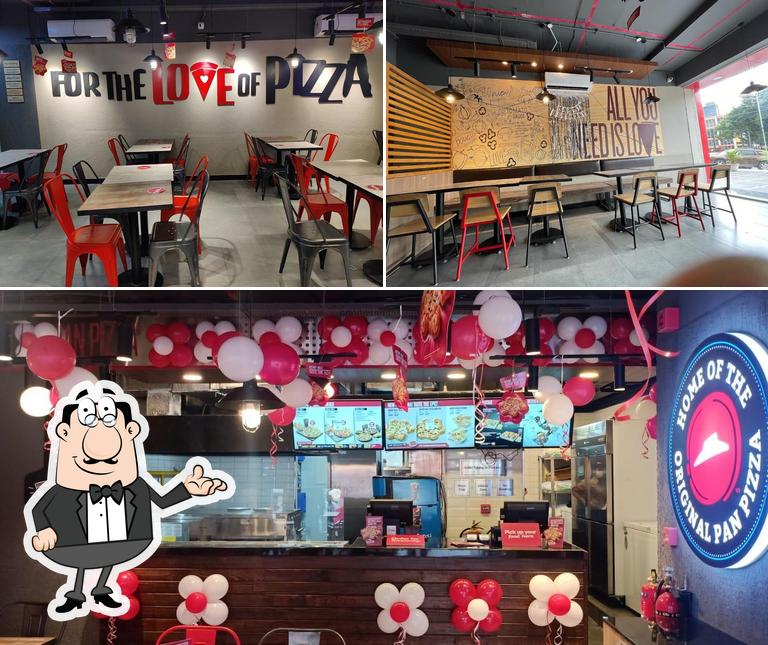 Take a seat at one of the tables at Pizza Hut Kachiguda, Hyderabad