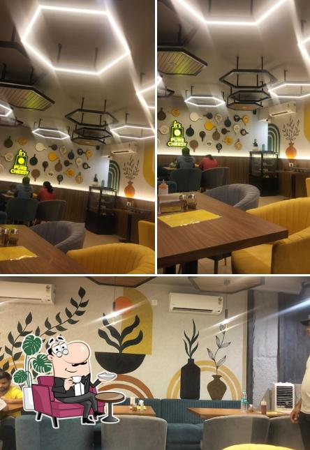 Take a seat at one of the tables at Crazy Cheesy Belgaum