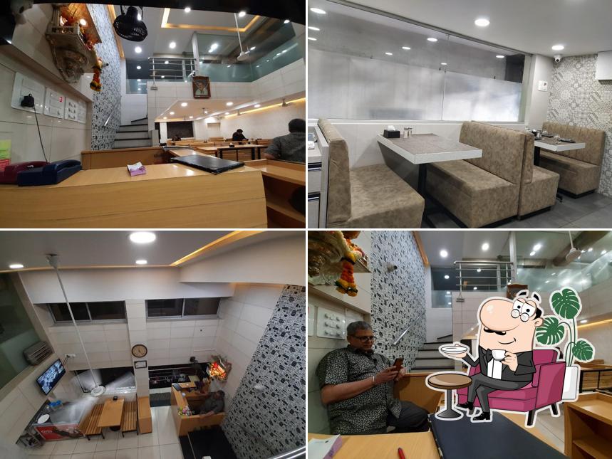 Take a seat at one of the tables at Hotel Sarovar KALWA