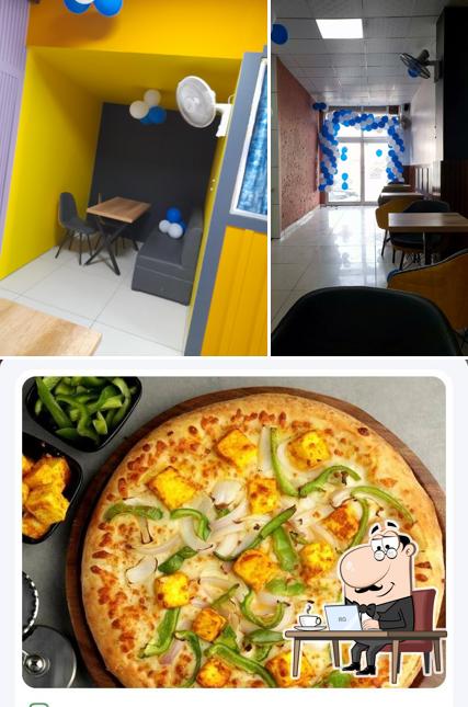 Check out the image displaying interior and pizza at Pizza circuit jhajjar