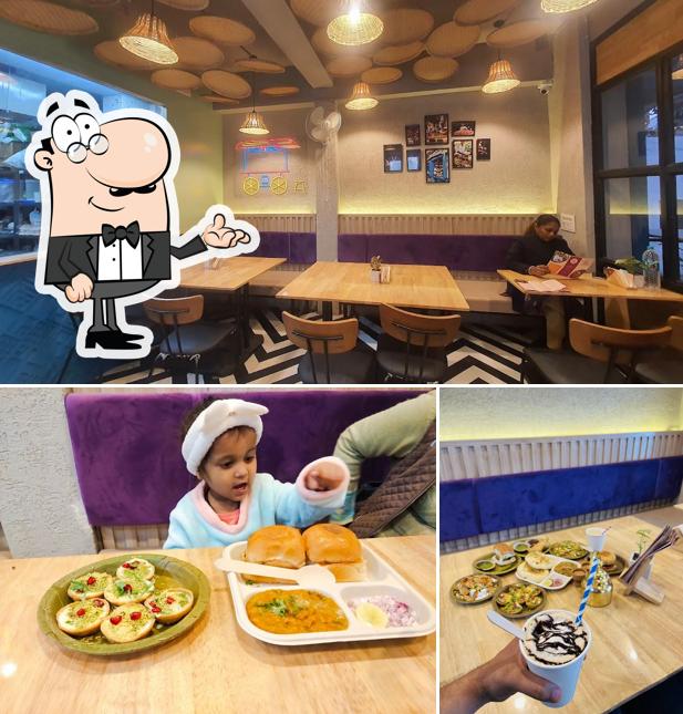 Take a seat at one of the tables at Chaat Ghar