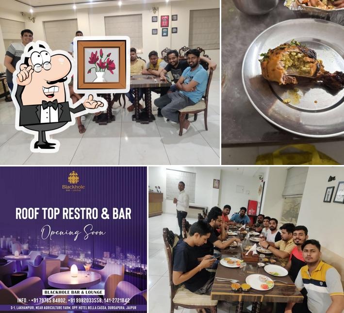 Take a seat at one of the tables at Black Hole Bar & Lounge