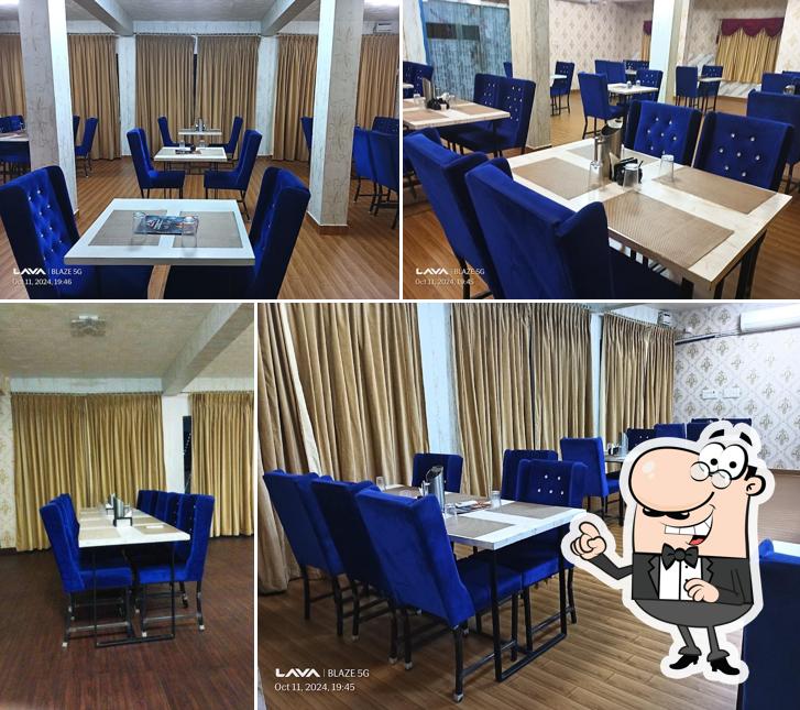 Take a seat at one of the tables at Wonder Multi Cusine Restaurant