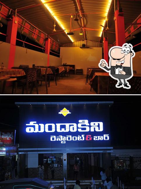 Take a seat at one of the tables at Mandakini Restaurant & Bar