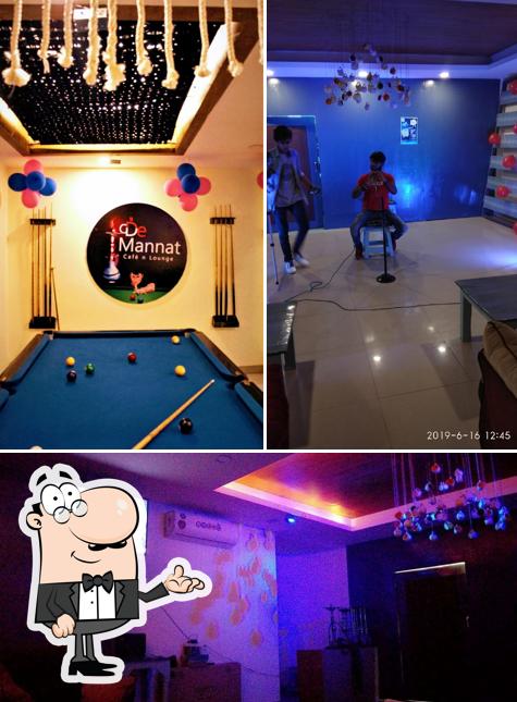 Take a seat at one of the tables at De Mannat Cafe N Lounge