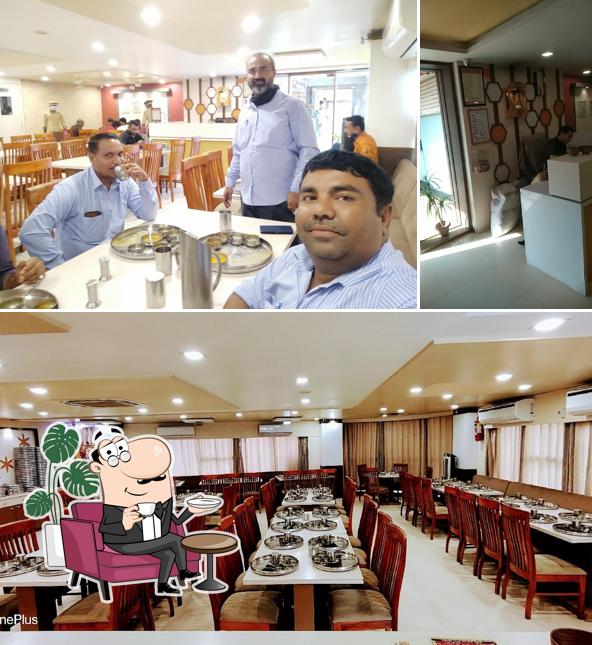 Take a seat at one of the tables at Raghuvanshi Thal Gujrati Thali