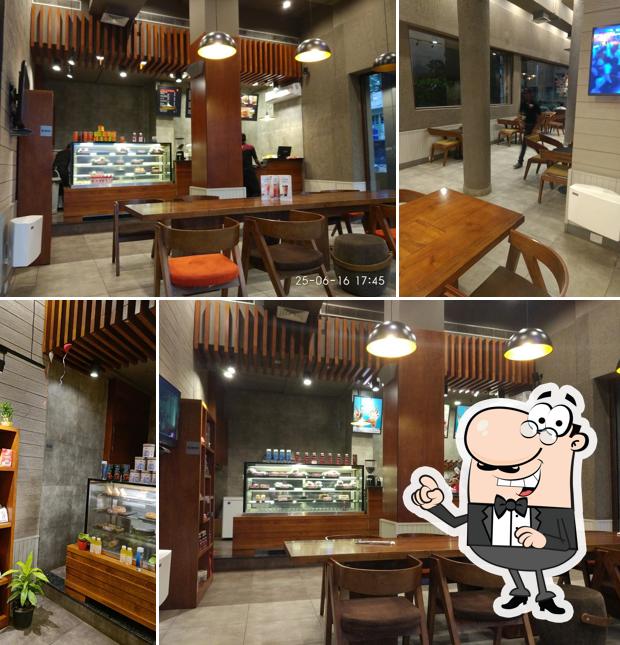 Take a seat at one of the tables at Café Coffee Day