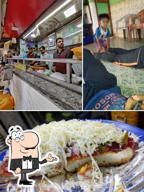 Take a look at the photo showing interior and food at Pinky Pizza & Sandwich Parlour