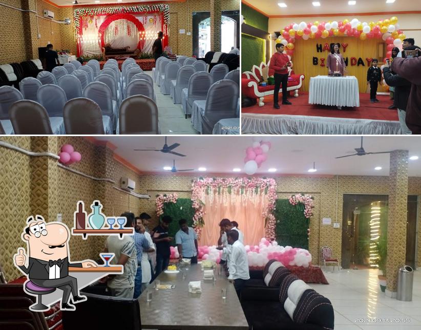 Take a seat at one of the tables at Nakshatra Veg Restaurant and banquet hall