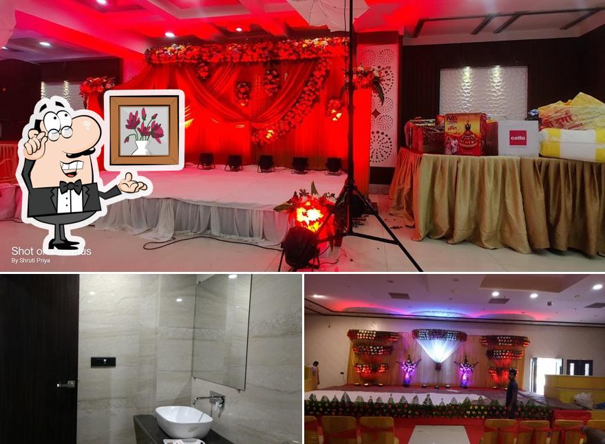 Take a seat at one of the tables at Hotel Surabhi International