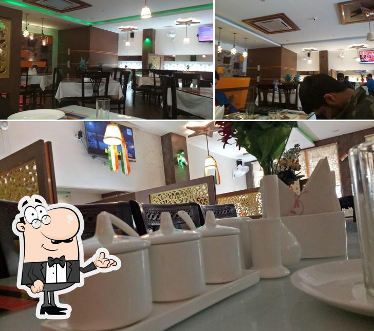 Take a seat at one of the tables at Kashmir Flavours Restaurant