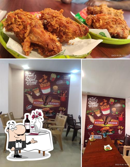 This is the photo depicting dining table and food at Sizzlly Chicken