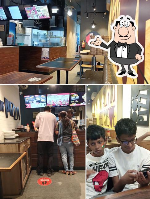 Take a seat at one of the tables at Pizza Hut Baramunda, Bhubaneswar