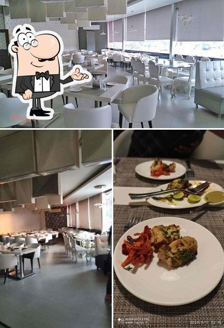 Take a seat at one of the tables at Shimla Biryani Restaurant - EM Bypass