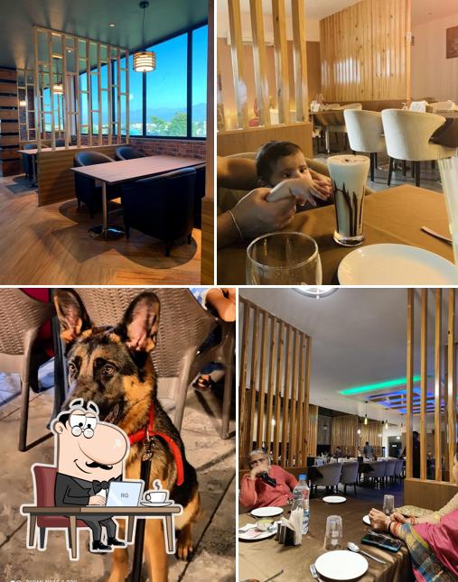 Take a seat at one of the tables at Mokshda Premium Hotel & Restaurant