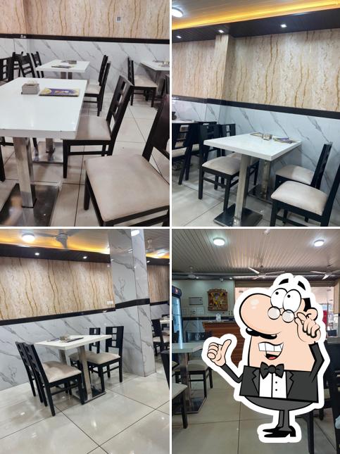 Take a seat at one of the tables at Sai Sagar pure veg restaurant