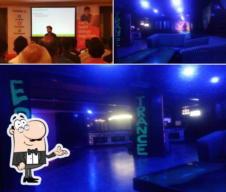 Take a seat at one of the tables at Poison Bar - The Checkers Hotel