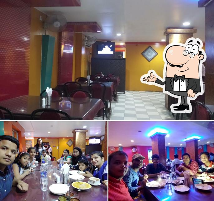 Take a seat at one of the tables at Harekrishna AC Veg Restaurant