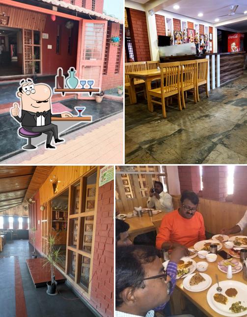 Take a seat at one of the tables at Hotel Sadguru pure veg best family restaurant