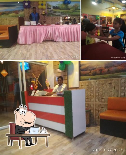 Take a seat at one of the tables at Sukh Saagar Veg Restaurent