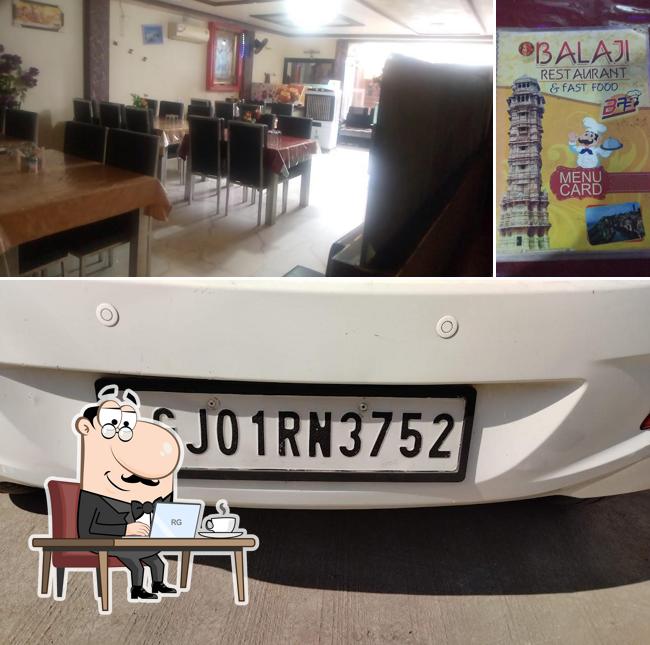 Take a seat at one of the tables at Balaji Restaurant