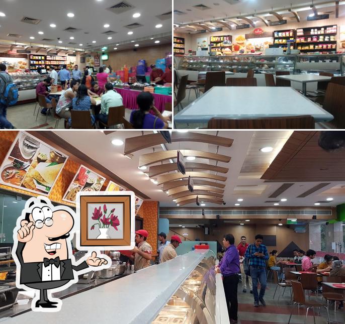 Take a seat at one of the tables at Haldiram's - Lajpat Nagar