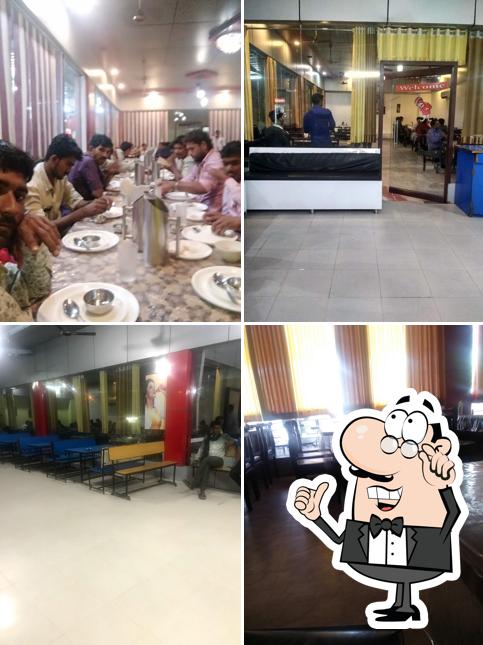 Take a seat at one of the tables at Hotel Maniraj :A.C. Dinning and Restaurant