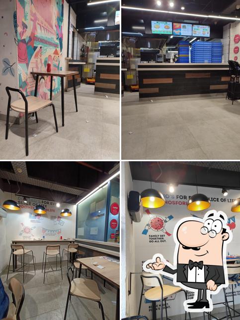 Take a seat at one of the tables at Domino's Pizza Railway Station, Raipur