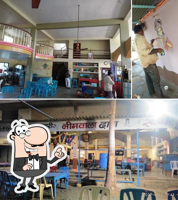 Take a seat at one of the tables at Neem Wala Dhaba,