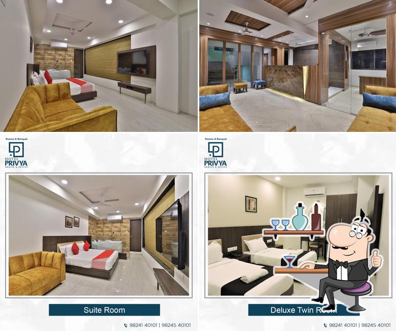 Take a seat at one of the tables at Hotel Privya Surat - Rooms & Banquet