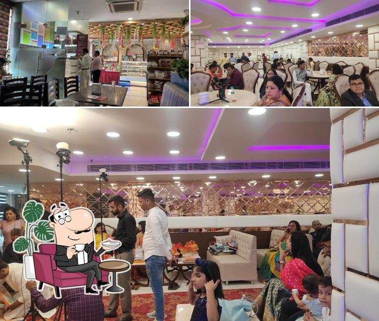 Take a seat at one of the tables at Shri Jee Shyam Dairy (sweets,restaurant, bakery)