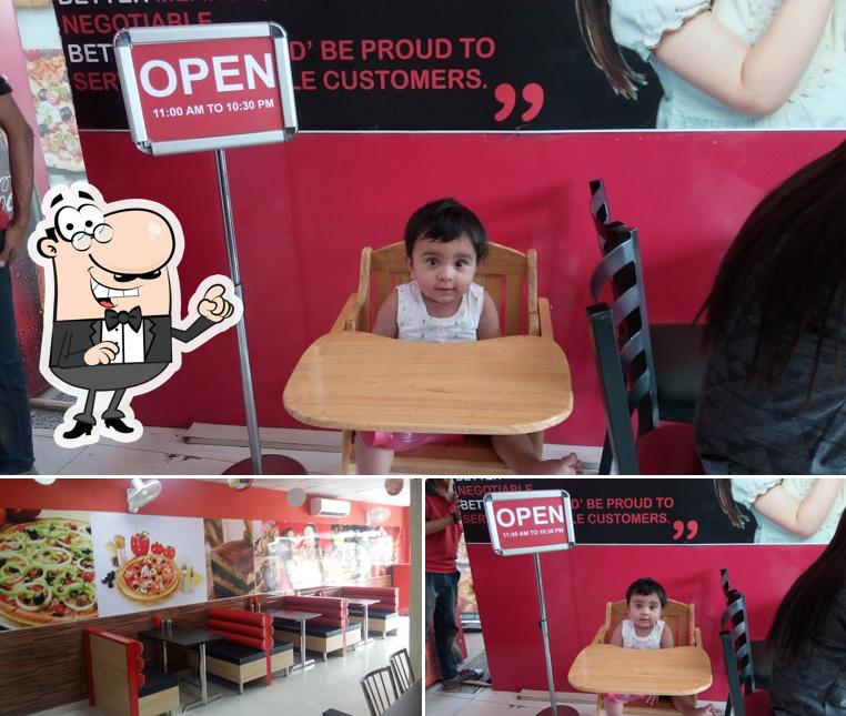 Take a seat at one of the tables at Pizza Galleria Panipat