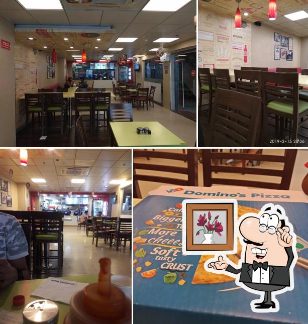 Take a seat at one of the tables at Domino's Pizza Guru Ram Das Market, Moga