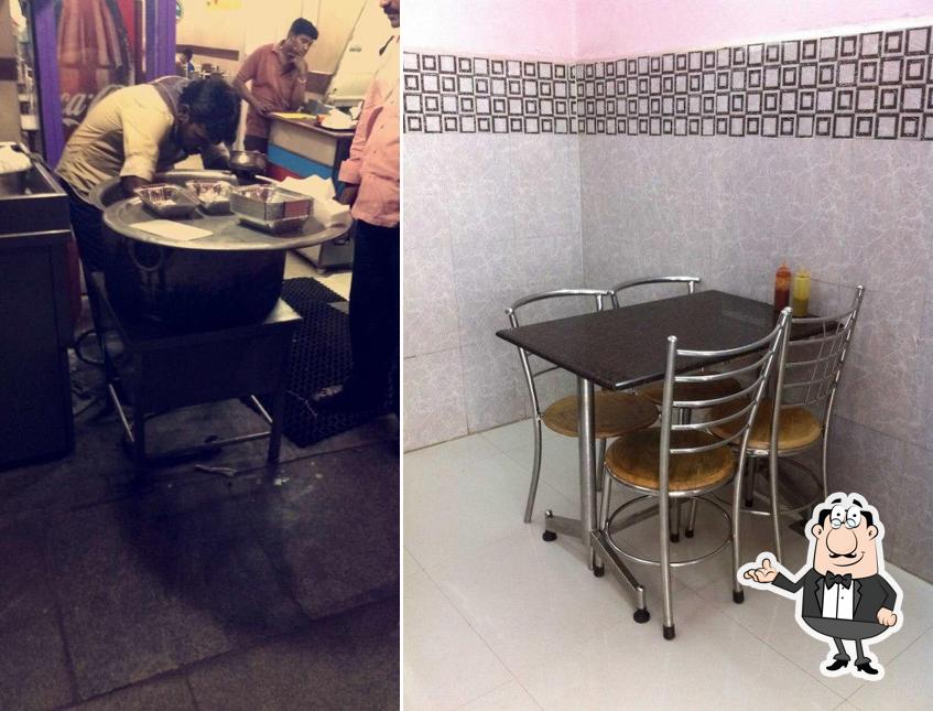 Take a seat at one of the tables at Chennai Halal Thalapakattuu Briyani & Fast Food