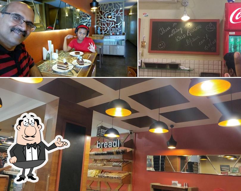 Take a look at the photo showing interior and blackboard at Wild Sugar Patisserie & Cafe - Dr. Ambedkar Road, Belgaum