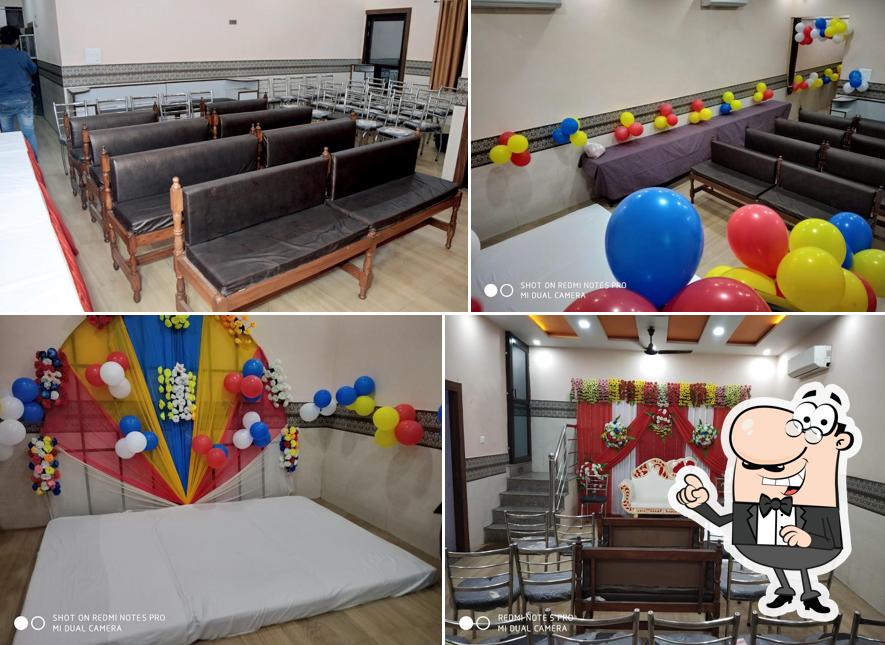 Take a seat at one of the tables at Rameshwaram Hotel & Restaurant