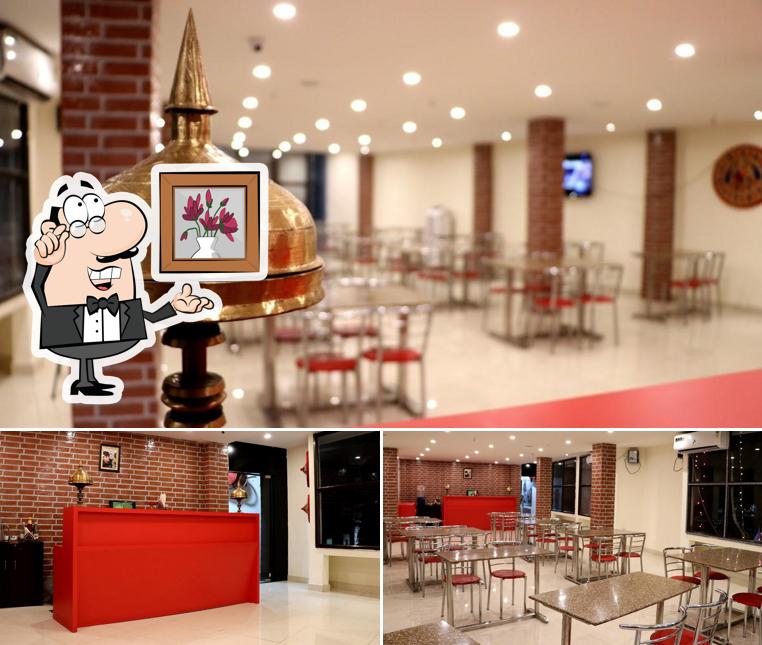 Take a seat at one of the tables at PK Family AC Restaurant