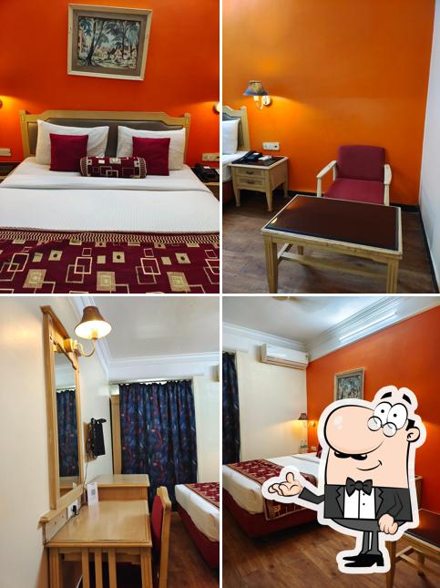 Take a seat at one of the tables at HOTEL SOVEREIGN (Pure Veg)