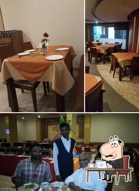 Take a seat at one of the tables at Sangam Multi Cuisine Restaurant