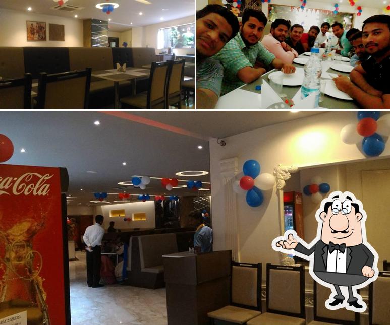 Take a seat at one of the tables at Aroma Restaurant