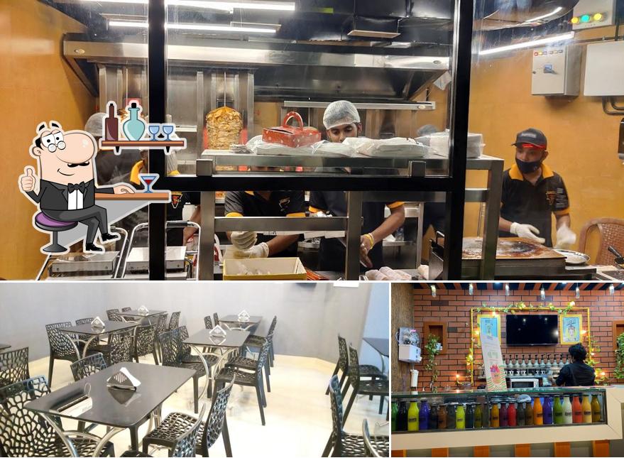 Take a seat at one of the tables at Al Taza - Aluva