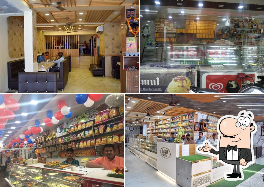 Take a seat at one of the tables at Krishna misthan Bhandar & Restaurant