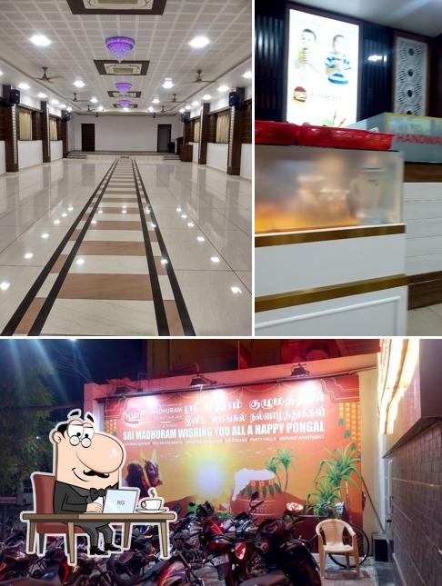 Take a seat at one of the tables at Sri Madhuram Veg Restaurant