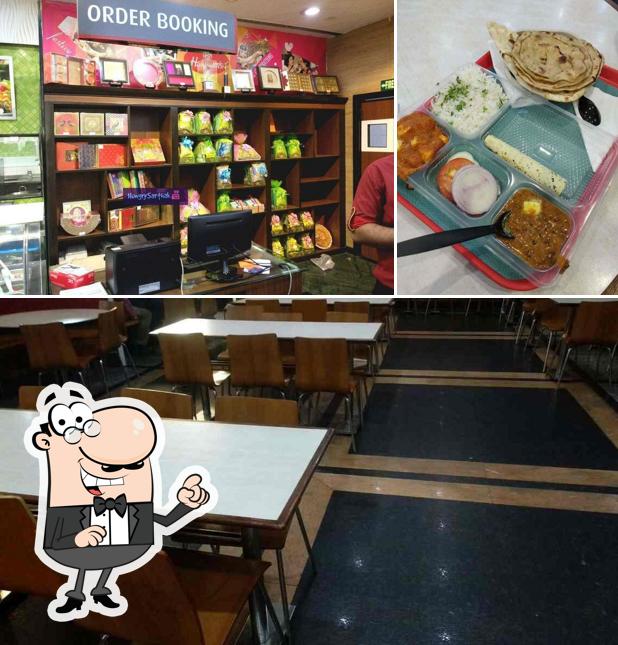 Take a seat at one of the tables at Haldiram's - Dilshad Garden