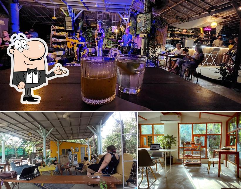 Take a seat at one of the tables at Barefoot Goa : Coffee, Cocktails, Clean food & Gigs