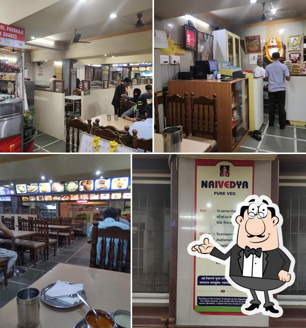 Take a seat at one of the tables at Hotel Naivedya