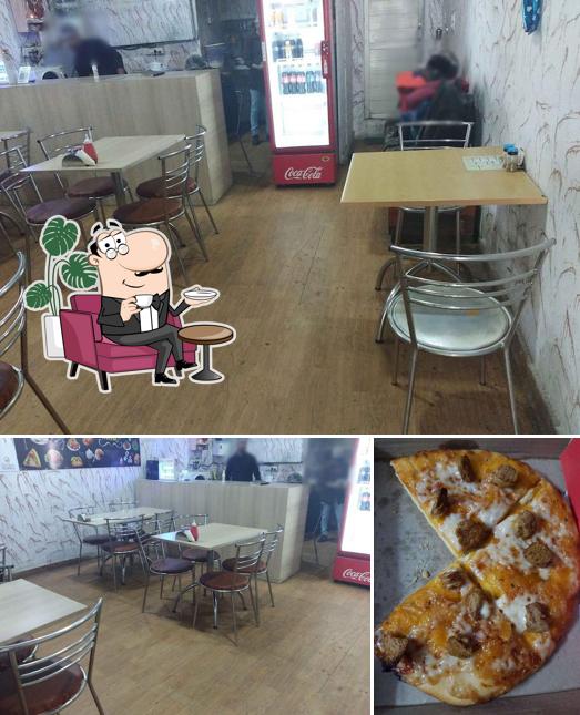 Check out the image depicting interior and pizza at Bunker's place