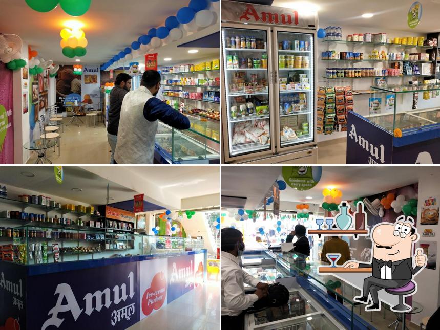 Take a seat at one of the tables at Amul Ice cream parlour, Cafe and Store