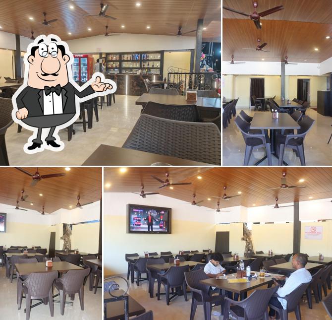 Take a seat at one of the tables at Kinara Multicuisine Restaurant & Bar, Colva