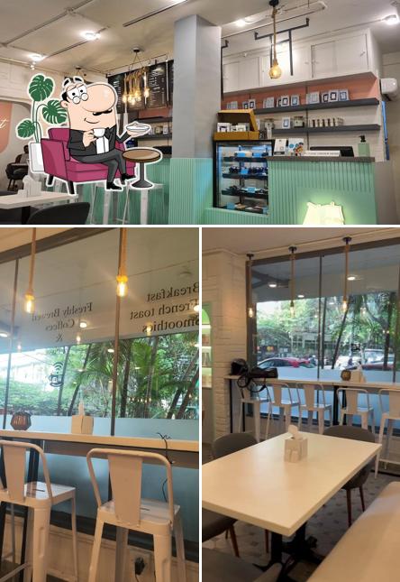 Take a seat at one of the tables at Cafe Muziris